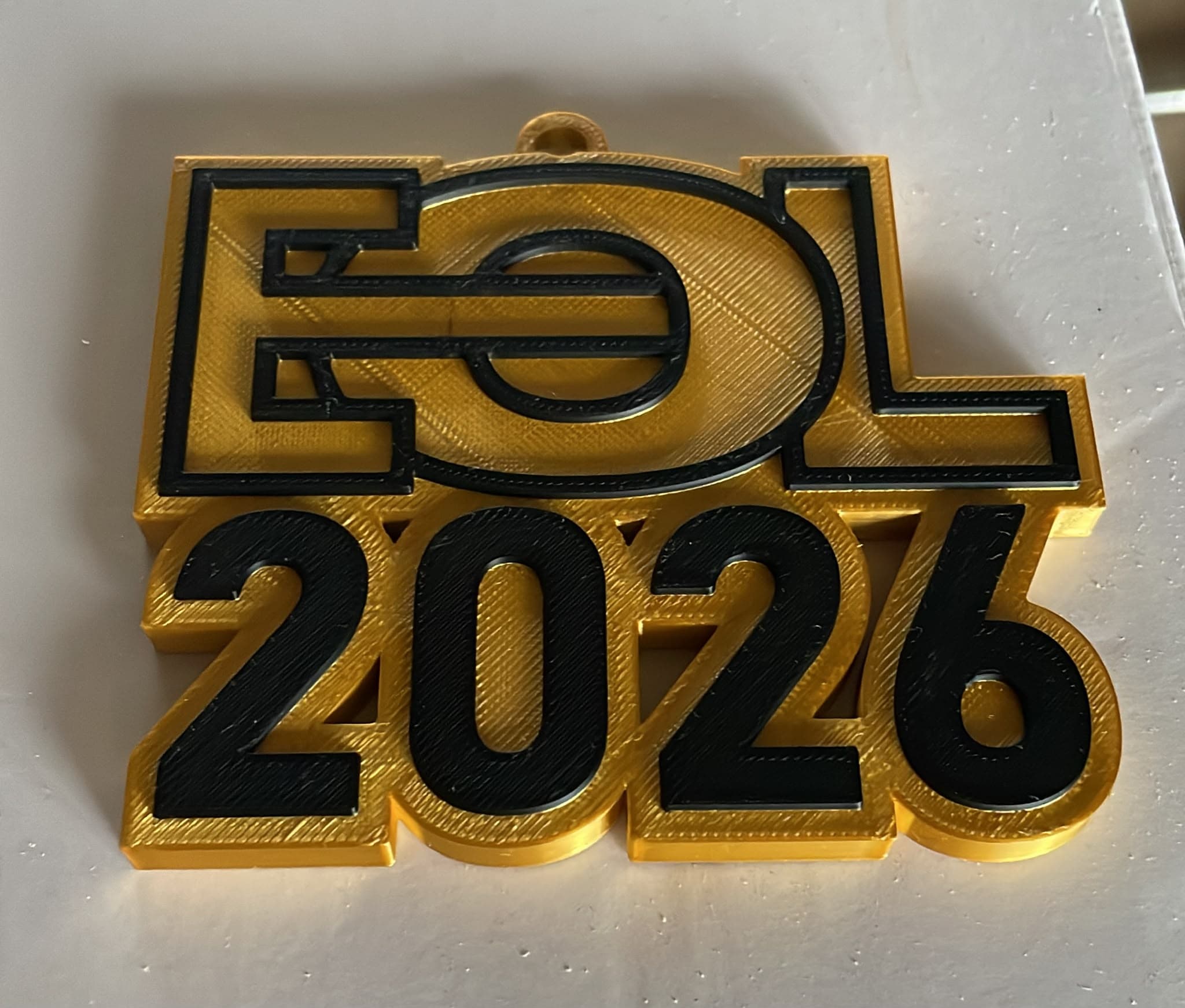 White and black EOL medal on a lanyard